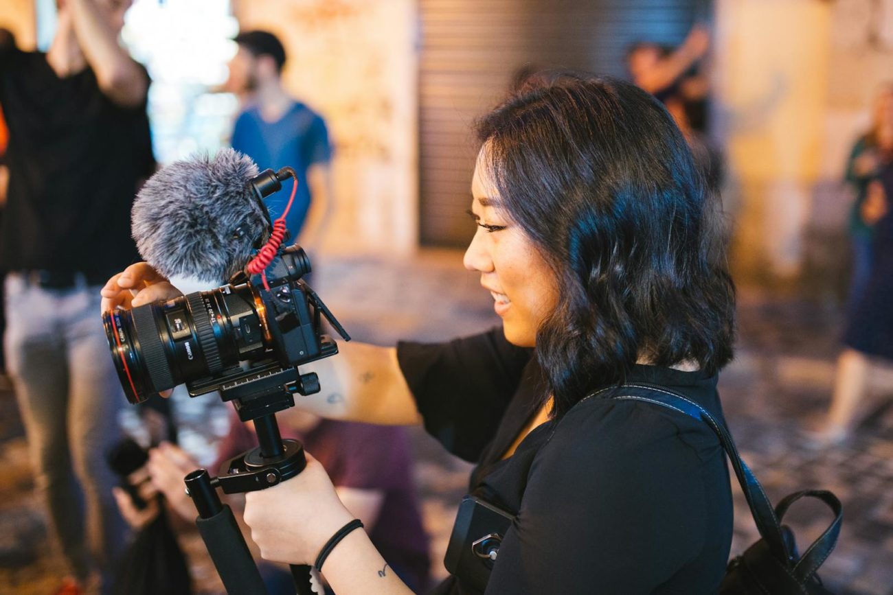 Smiling Woman Holding Black Dslr Camera